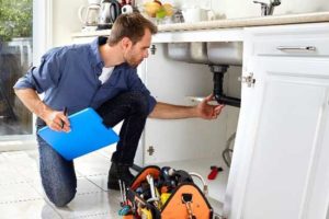 man-under-sink-plumber