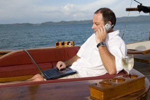 man on boat with lap top