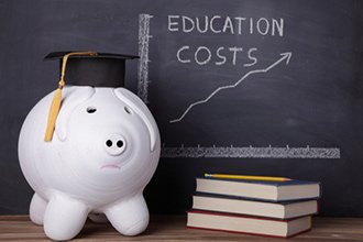 piggy bank next to a n education costs rising chart