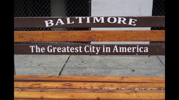 A wooden bench with a sign Description automatically generated with low confidence